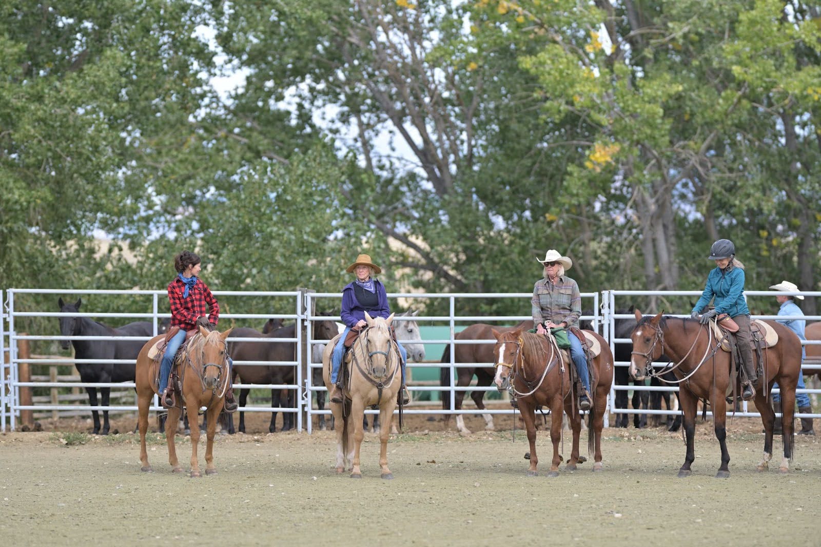 Riders galloping across stunning Wyoming wilderness