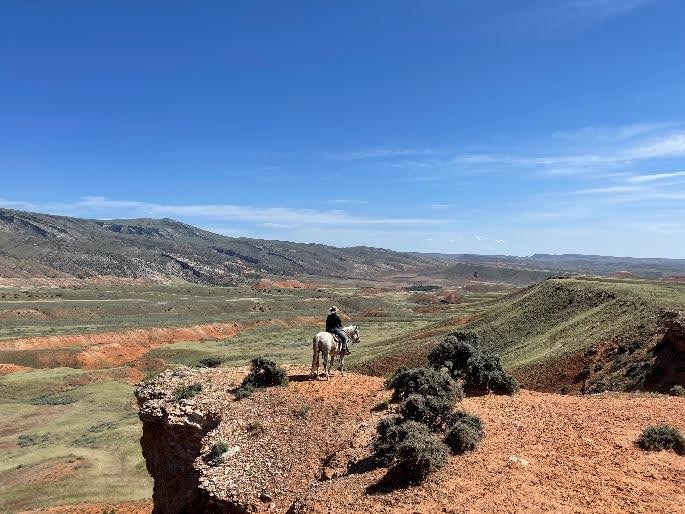 Riders galloping across stunning Wyoming wilderness