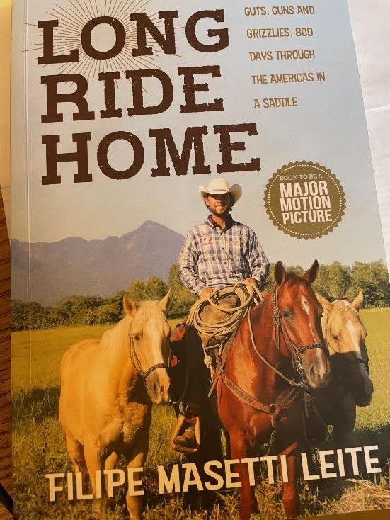 Riders galloping across stunning Wyoming wilderness