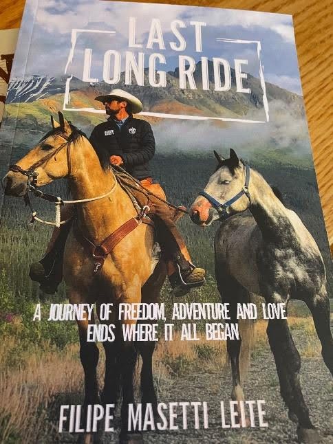 Riders galloping across stunning Wyoming wilderness