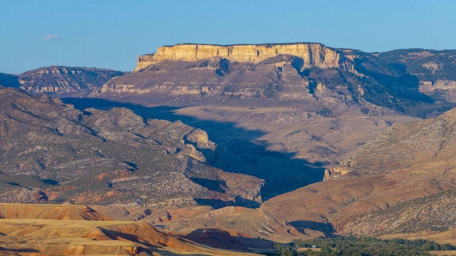 Layered rocky ridges above a wide mountain valley.