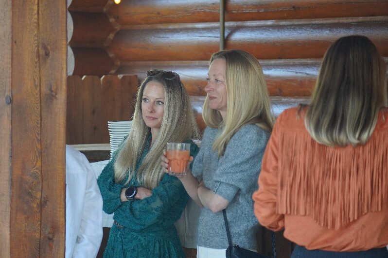 Guests talking inside a ranch building