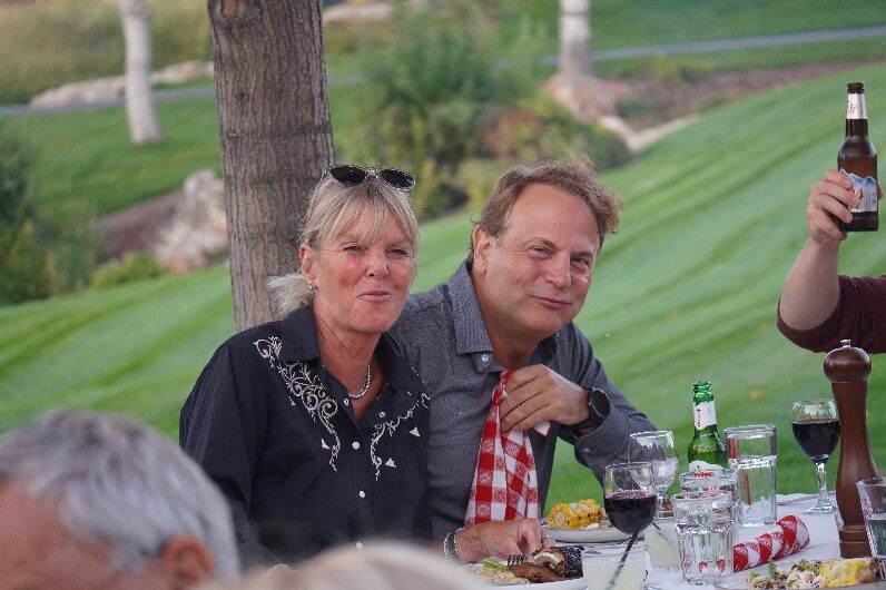 Guests sharing drinks at an outdoor meal